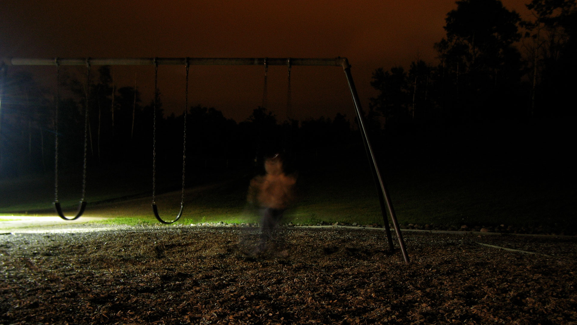 A playground at night, spooky